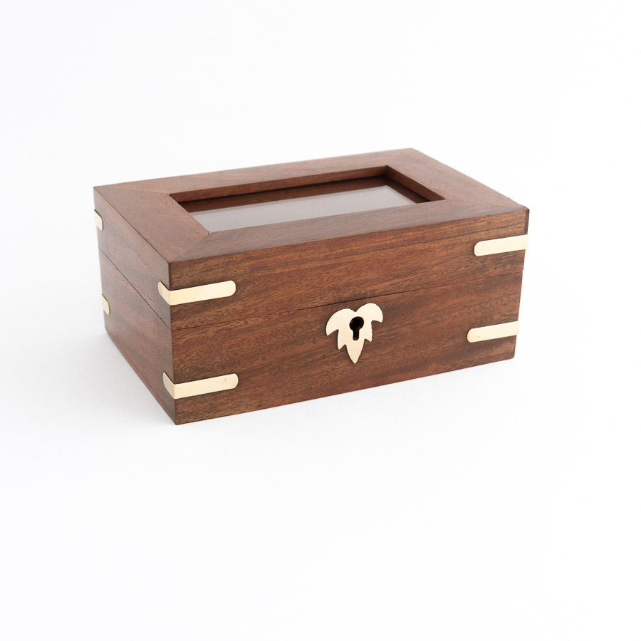 Rosewood timber memorial box with brass corner inlays and a glass lid